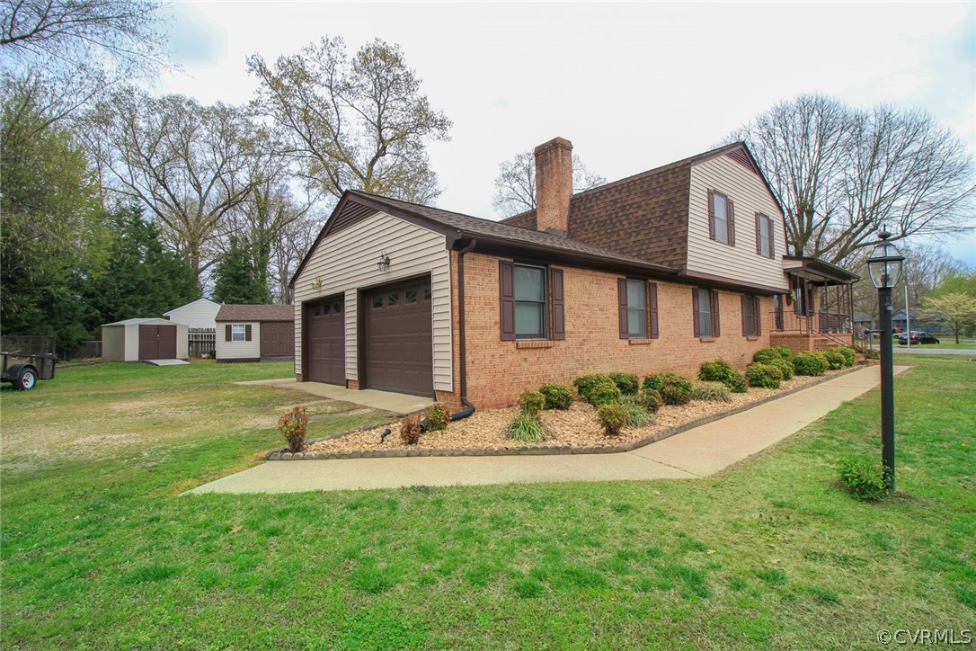 1500 Austin Road Chester, VA 23836 - Photo 3 of 30 a front view of a house with a garden and yard