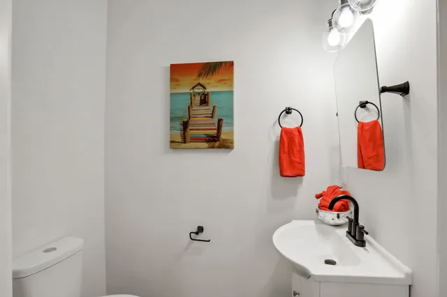 a kitchen with stainless steel appliances sink a refrigerator and white cabinets