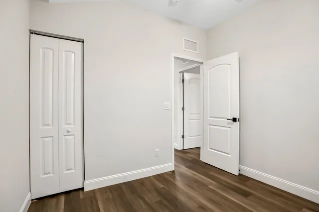 an empty room with wooden floor