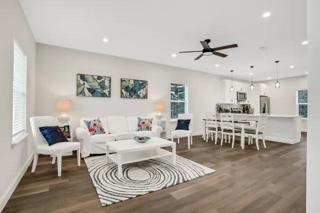 a living room with furniture a rug and a table