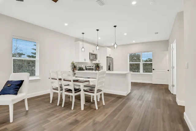a view of a dining room with furniture window and wooden floor