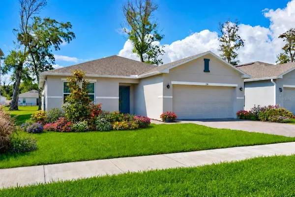 a front view of a house with a garden
