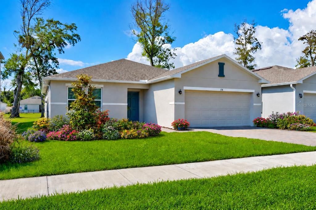 a front view of a house with a garden