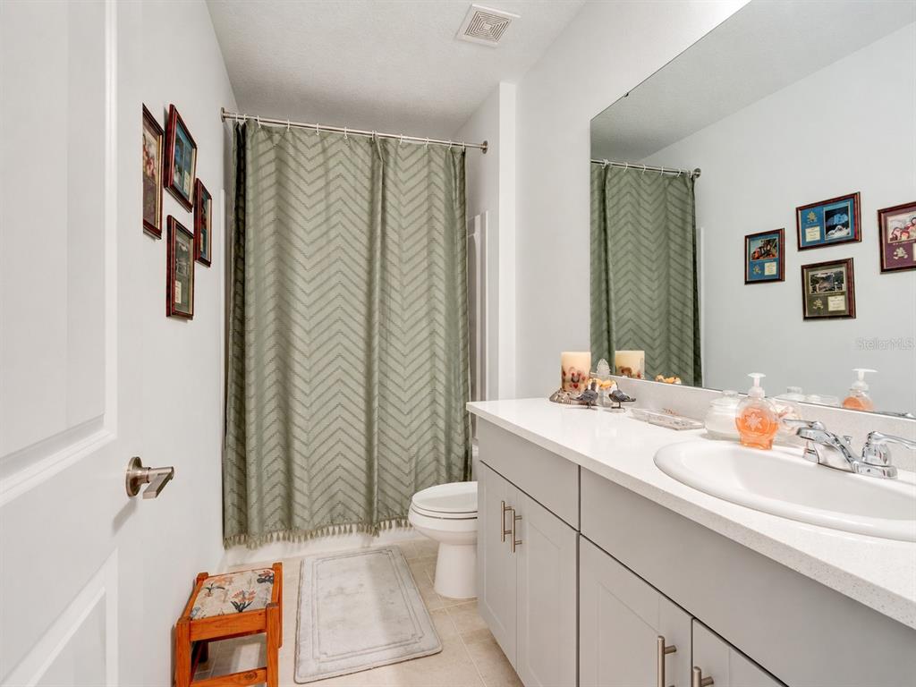 176 Jones Fish Camp Road Edgewater, FL 32141 - Photo 13 of 30 a bathroom with a sink a toilet and shower curtain