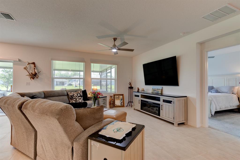 176 Jones Fish Camp Road Edgewater, FL 32141 - Photo 5 of 30 a living room with furniture and a flat screen tv