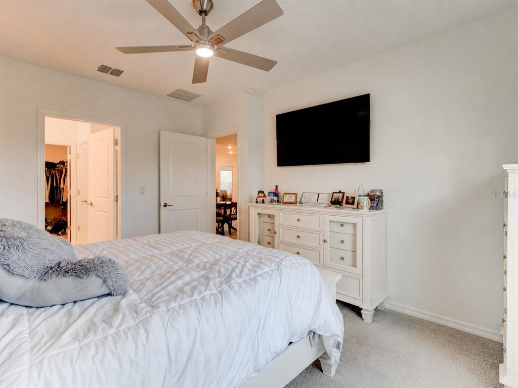 176 Jones Fish Camp Road Edgewater, FL 32141 - Photo 10 of 30 a bedroom with a bed and a flat screen tv