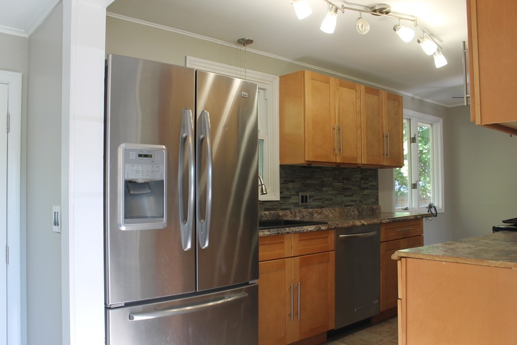 377 Stapleton Road Springfield, MA 01109 - Photo 6 of 17 a kitchen with stainless steel appliances granite countertop a refrigerator and a sink