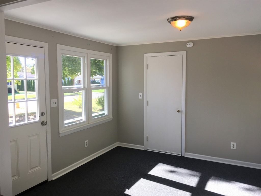 377 Stapleton Road Springfield, MA 01109 - Photo 8 of 17 an empty room with wooden floor and windows