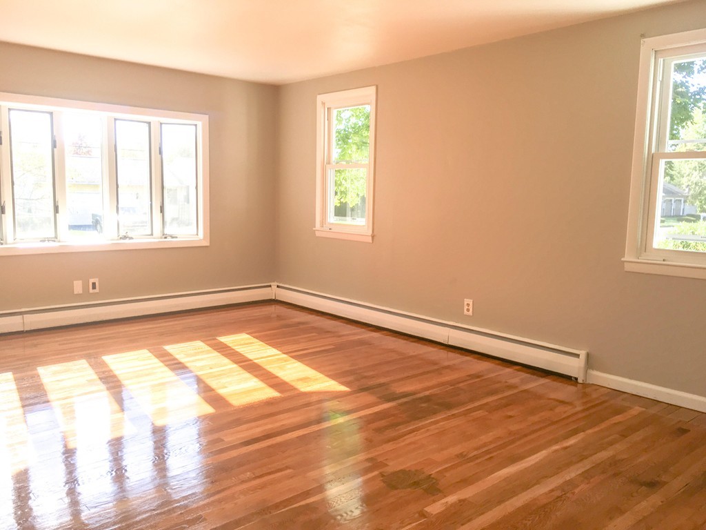 377 Stapleton Road Springfield, MA 01109 - Photo 9 of 17 a view of an empty room with wooden floor and a window