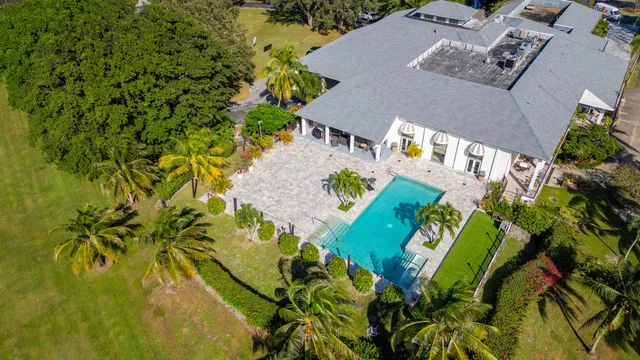 an aerial view of a house with a yard swimming pool a patio and garden