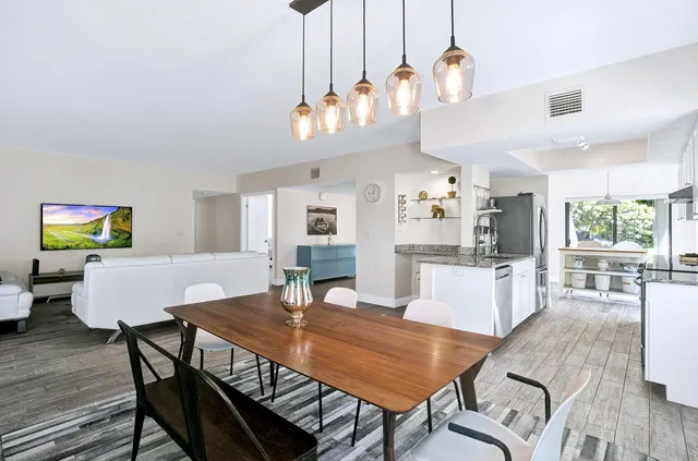 a view of a dining room with furniture window and wooden floor