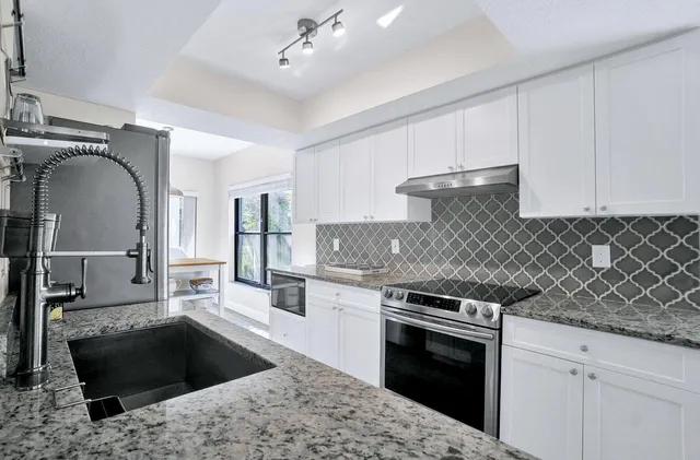 a kitchen with a stove and a sink