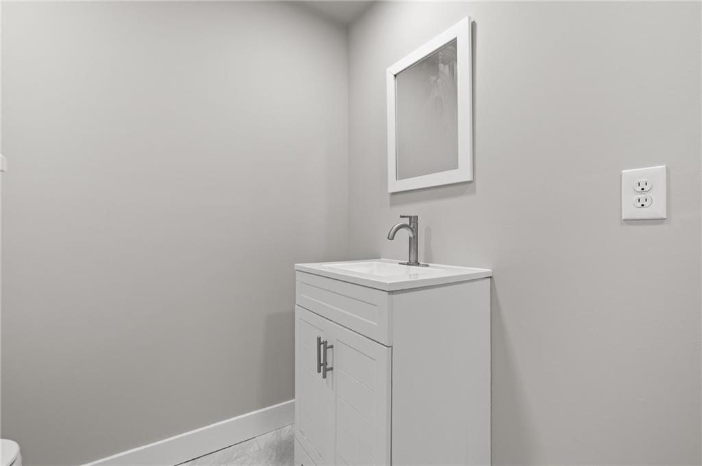 6470 Samoa Way Flowery Branch, GA 30542 - Photo 53 of 61 a bathroom with a sink and mirror