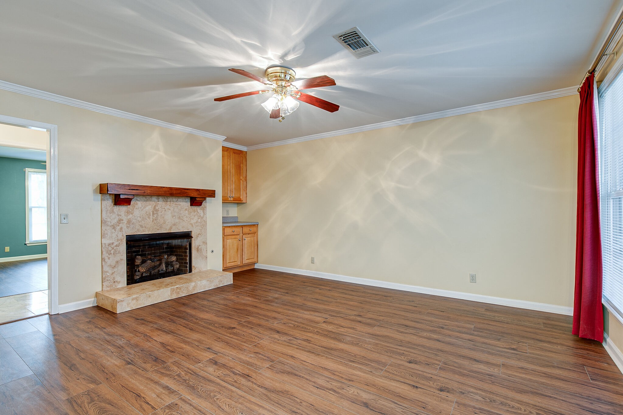 1066 General George Patton Road Nashville, TN 37221 - Photo 4 of 24 a view of an empty room with wooden floor fireplace and a window