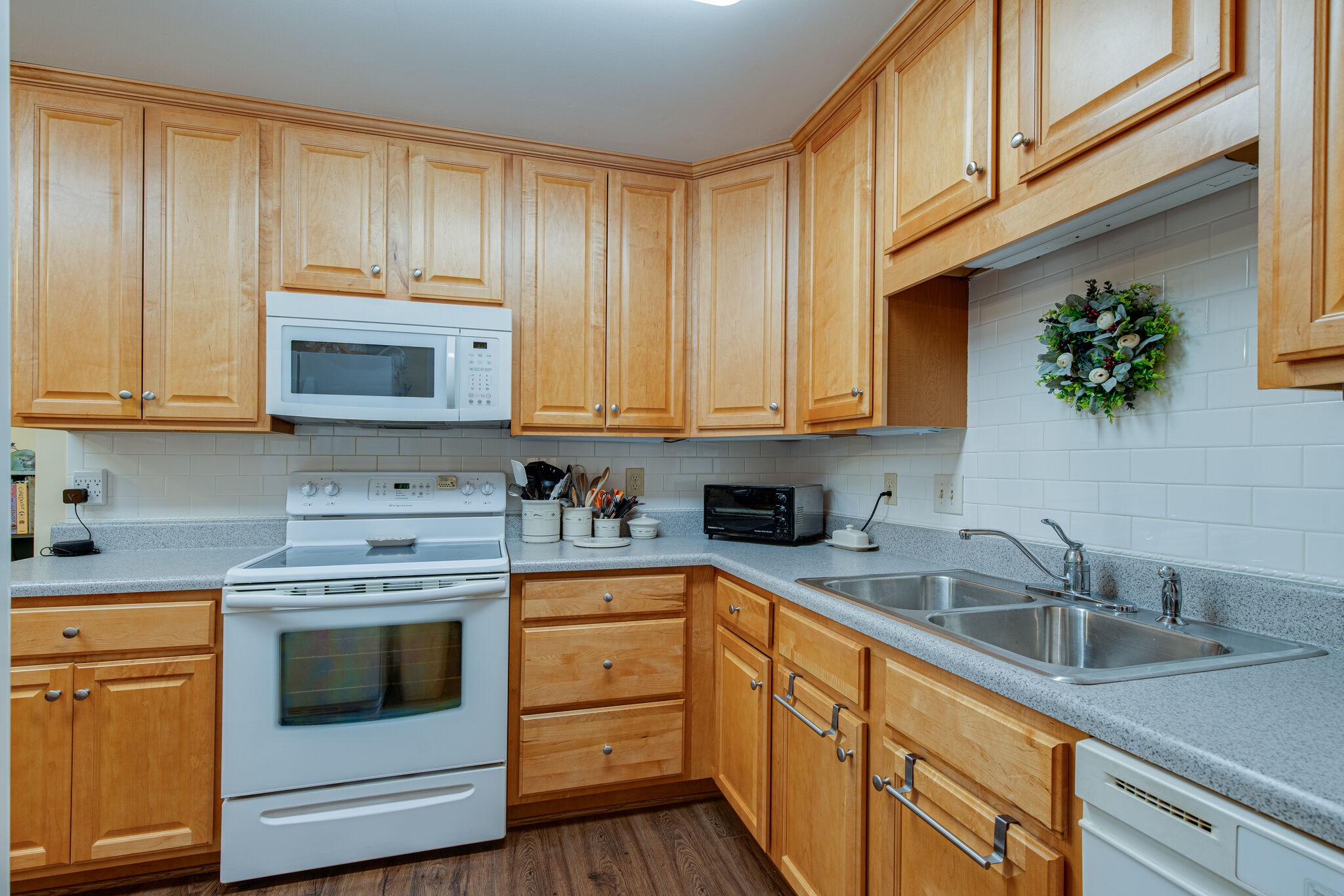 1066 General George Patton Road Nashville, TN 37221 - Photo 8 of 24 a kitchen with stainless steel appliances granite countertop white cabinets a stove a sink and a microwave