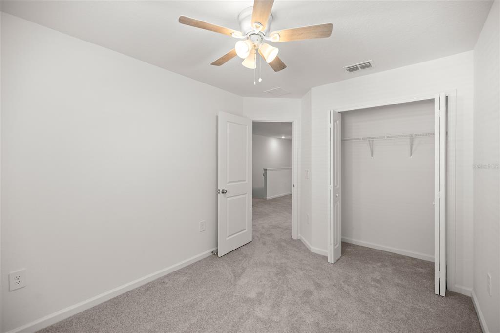 3339 Southeast 37th Ave Road Ocala, FL 34480 - Photo 19 of 21 an empty room with a ceiling fan and a bathroom