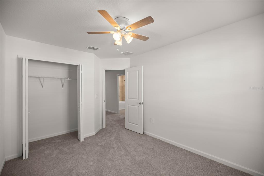 3339 Southeast 37th Ave Road Ocala, FL 34480 - Photo 21 of 21 an empty room with closet and a chandelier fan