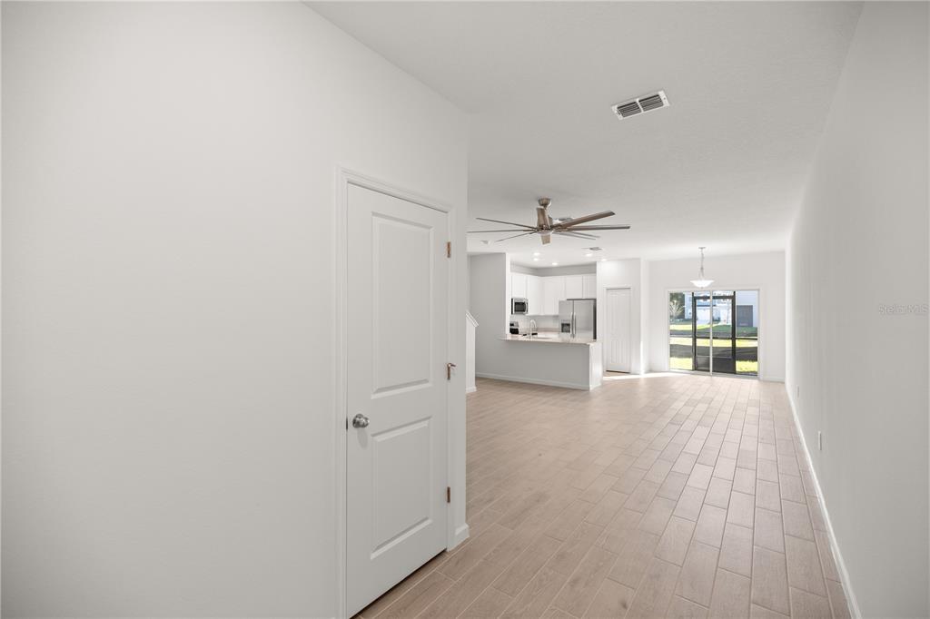 3339 Southeast 37th Ave Road Ocala, FL 34480 - Photo 4 of 21 a view of a big room with wooden floor and a kitchen