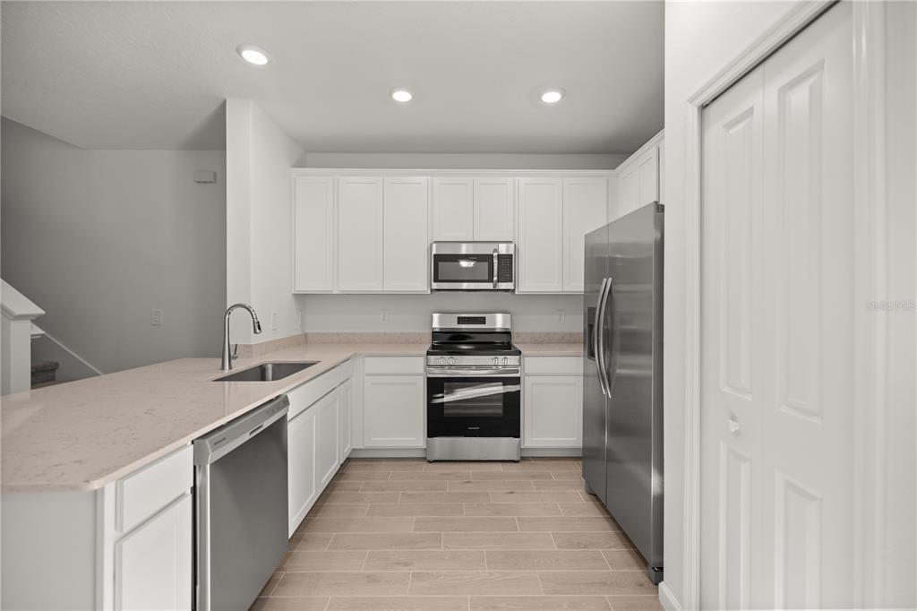 3339 Southeast 37th Ave Road Ocala, FL 34480 - Photo 7 of 21 a kitchen with a sink stainless steel appliances and cabinets