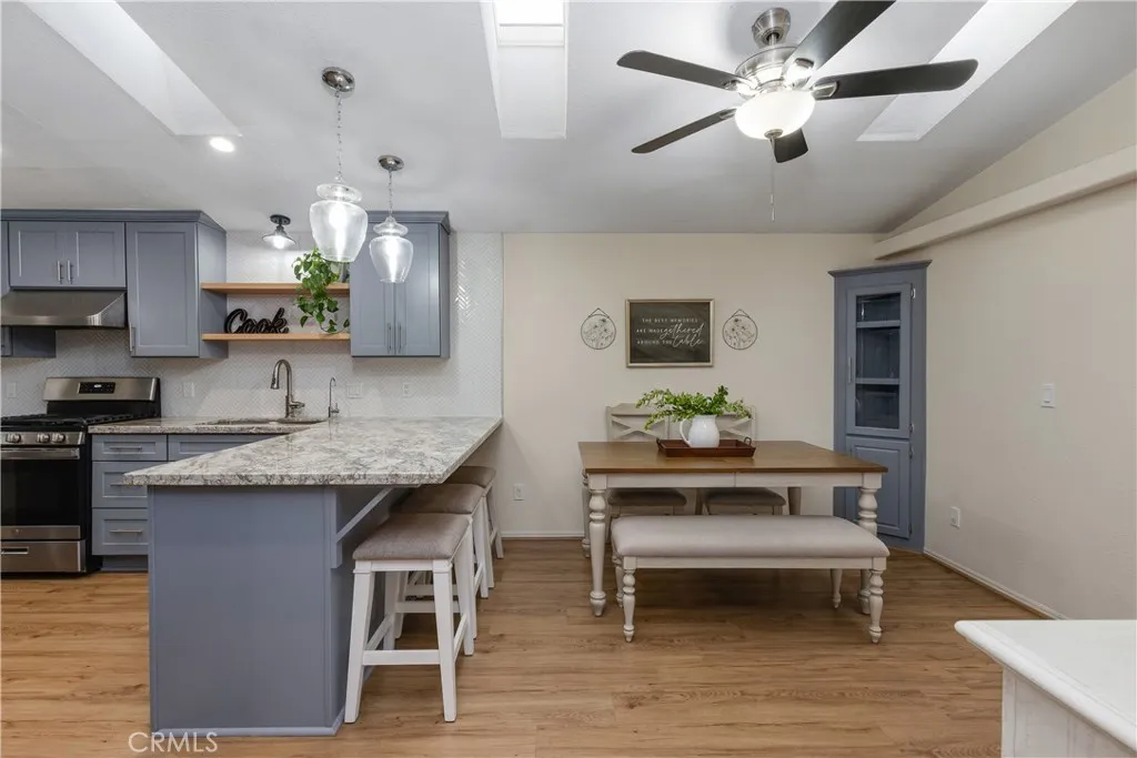1051 Site, Unit 89 Brea, CA 92821 - Photo 14 of 36 a kitchen with granite countertop a sink cabinets and wooden floor