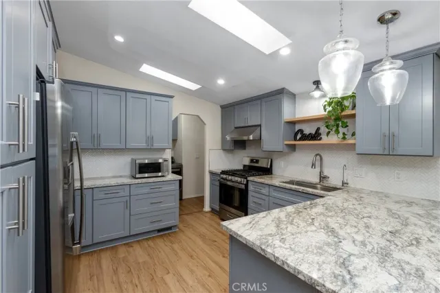 a kitchen with refrigerator cabinets and a sink