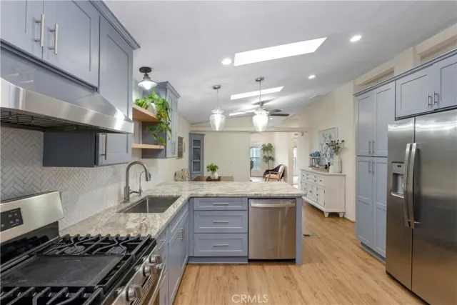 a kitchen with stainless steel appliances granite countertop a stove and a refrigerator