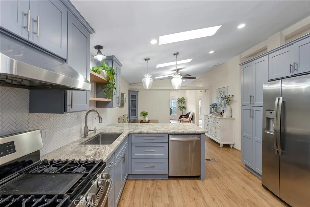 1051 Site, Unit 89 Brea, CA 92821 - Photo 18 of 36 a kitchen with stainless steel appliances granite countertop a stove and a refrigerator