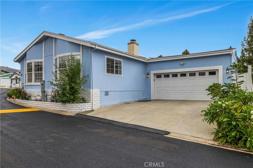 1051 Site, Unit 89 Brea, CA 92821 - Photo 2 of 36 a front view of a house with a yard and garage