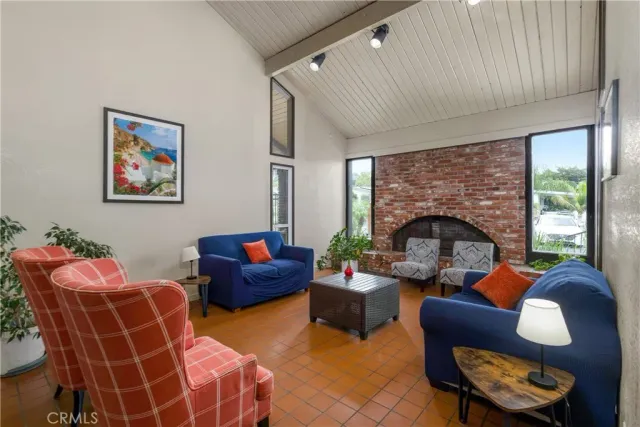 a living room with furniture a fireplace and a large window