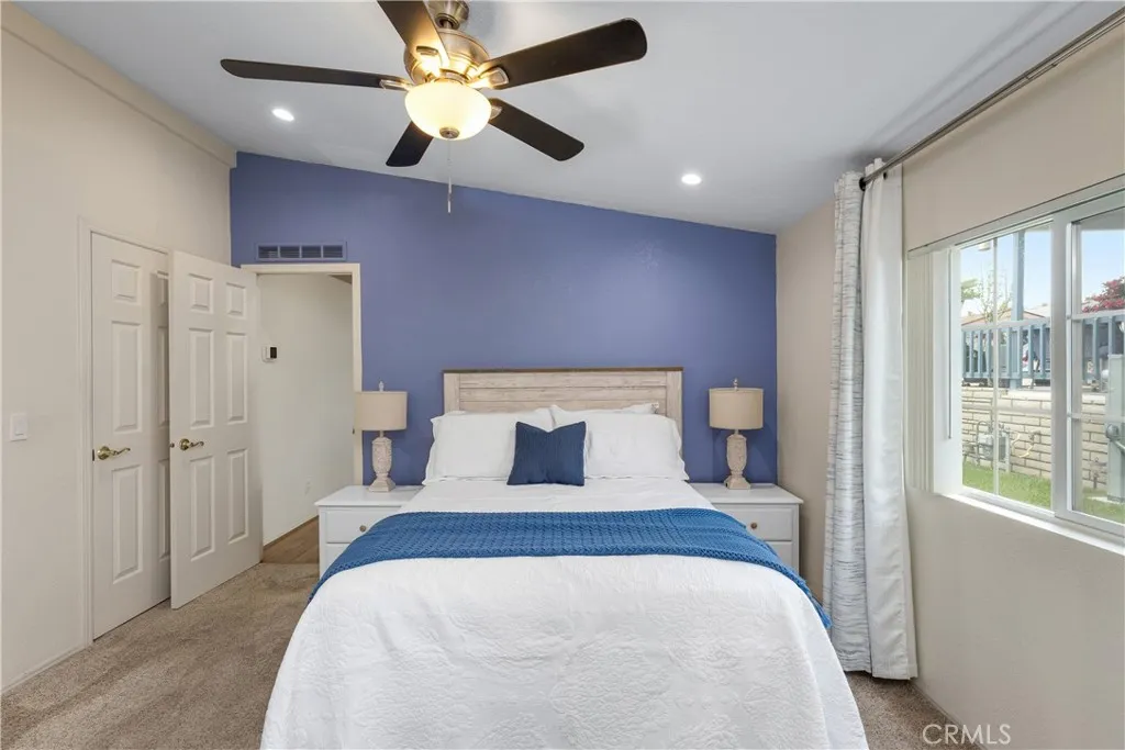 1051 Site, Unit 89 Brea, CA 92821 - Photo 10 of 36 a bedroom with a large bed and a chandelier