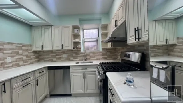 a kitchen with a sink stove and cabinets
