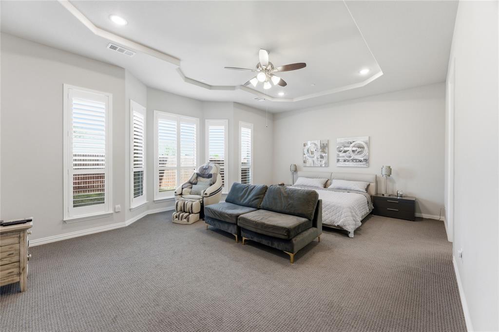 7705 Falcon Ridge Road Denton, TX 76208 - Photo 17 of 40 Carpeted bedroom featuring a raised ceiling, ceiling fan, and recessed lighting