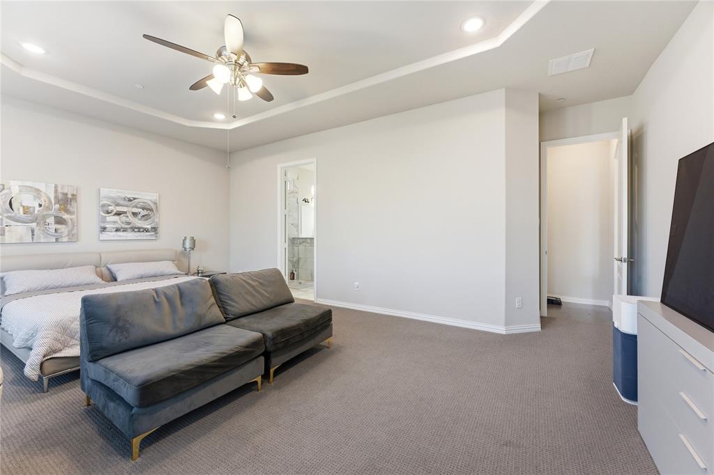 7705 Falcon Ridge Road Denton, TX 76208 - Photo 18 of 40 Carpeted bedroom featuring a raised ceiling, ceiling fan, and recessed lighting