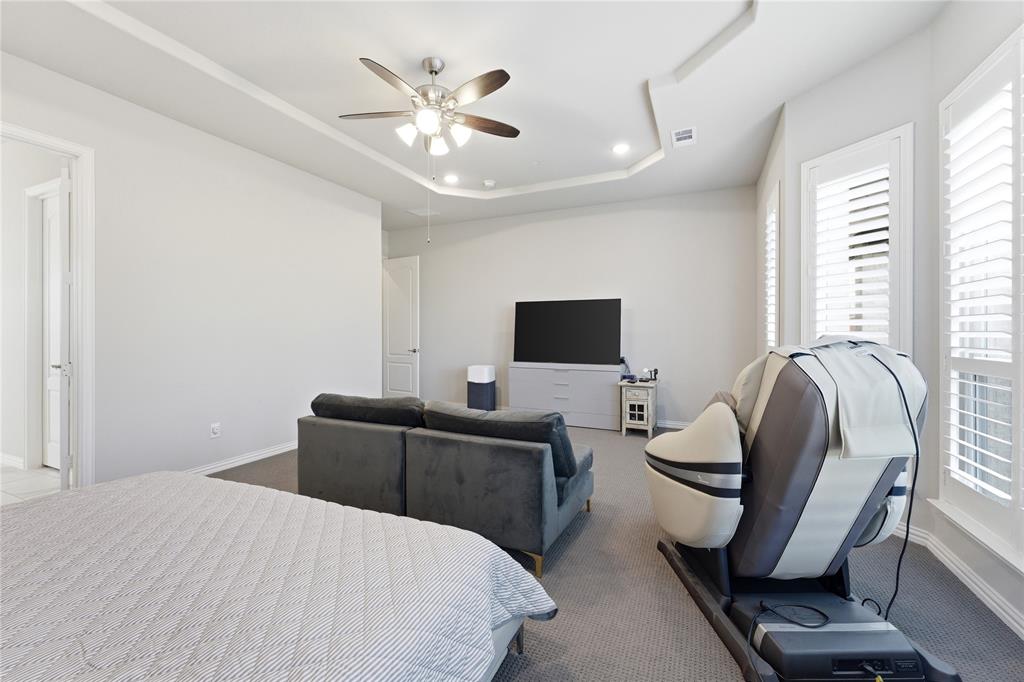 7705 Falcon Ridge Road Denton, TX 76208 - Photo 19 of 40 Carpeted bedroom featuring a raised ceiling, ceiling fan, and recessed lighting