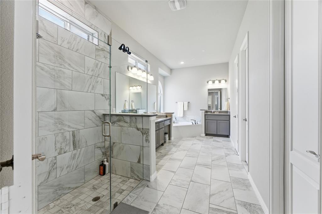 7705 Falcon Ridge Road Denton, TX 76208 - Photo 20 of 40 Full bathroom featuring a bath, a stall shower, light marble finish flooring, and two vanities