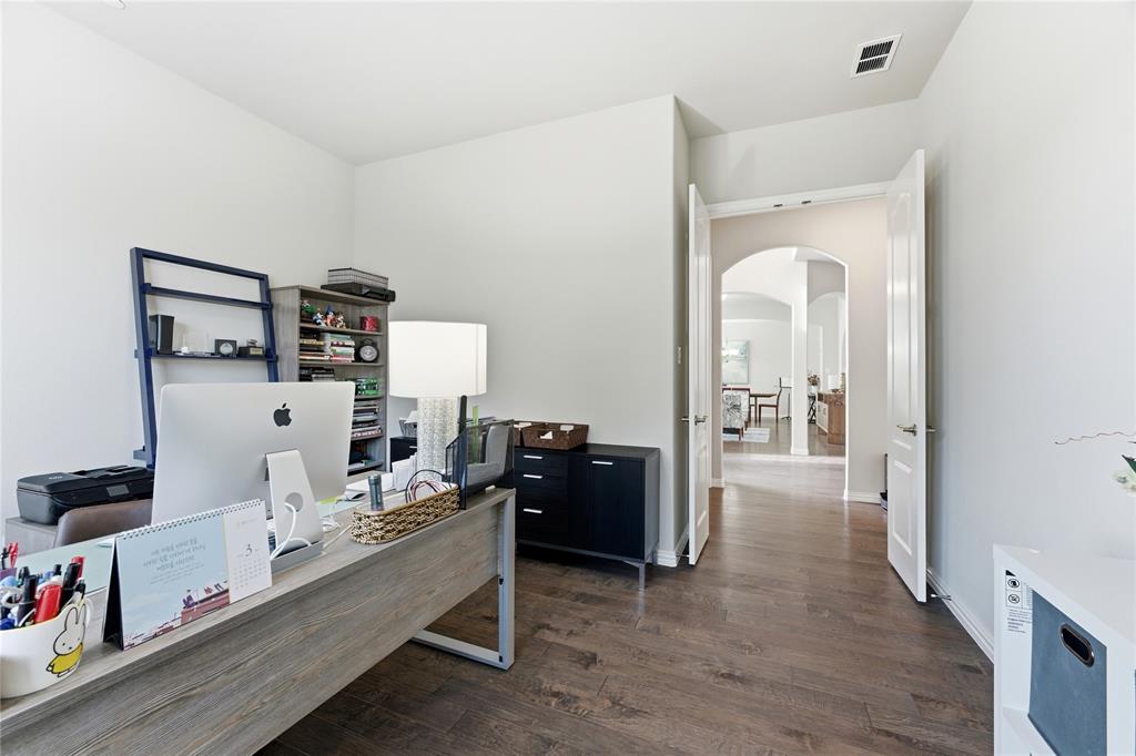7705 Falcon Ridge Road Denton, TX 76208 - Photo 22 of 40 Office area with arched walkways and dark wood finished floors