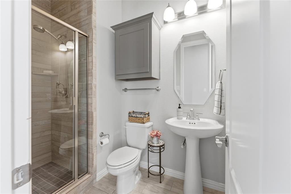 7705 Falcon Ridge Road Denton, TX 76208 - Photo 23 of 40 Full bathroom with toilet and a stall shower