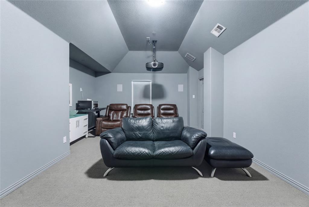 7705 Falcon Ridge Road Denton, TX 76208 - Photo 25 of 40 Cinema room featuring light carpet and baseboards