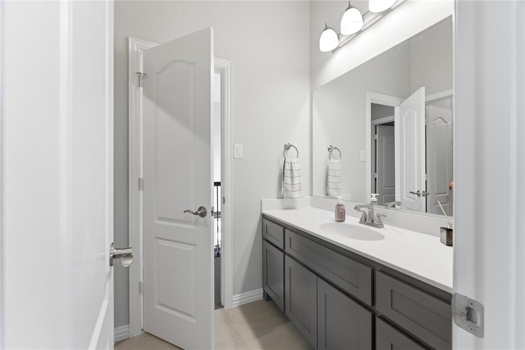 7705 Falcon Ridge Road Denton, TX 76208 - Photo 28 of 40 Bathroom featuring vanity and light tile patterned floors