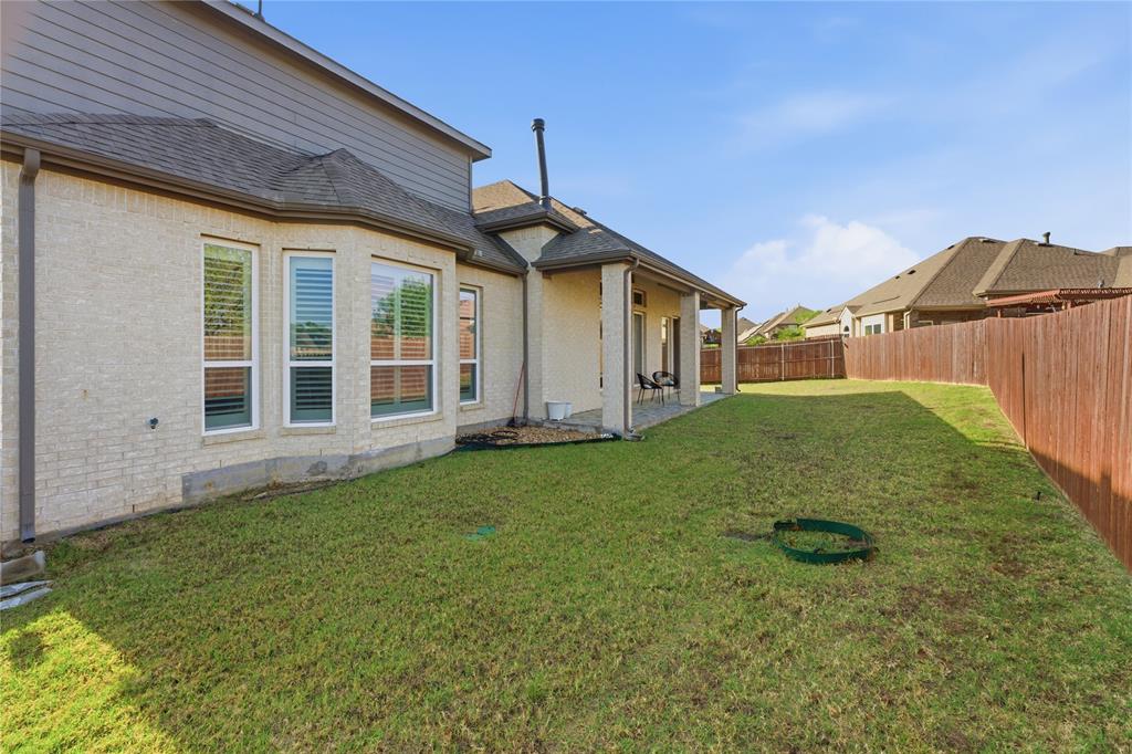 7705 Falcon Ridge Road Denton, TX 76208 - Photo 39 of 40 Fenced backyard with a patio area