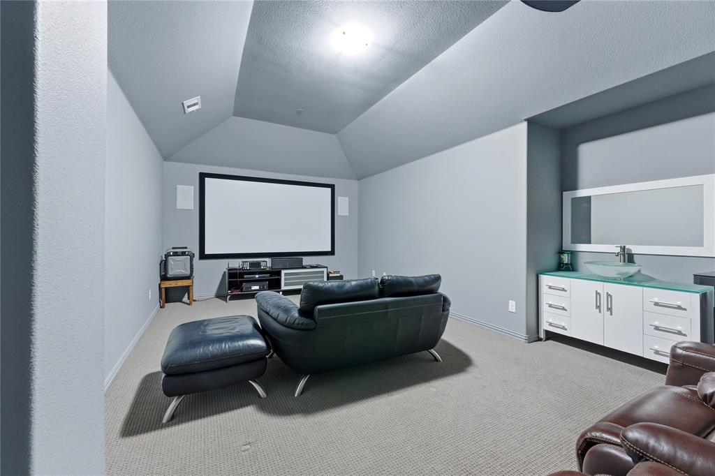 7705 Falcon Ridge Road Denton, TX 76208 - Photo 4 of 40 Cinema featuring light carpet and lofted ceiling