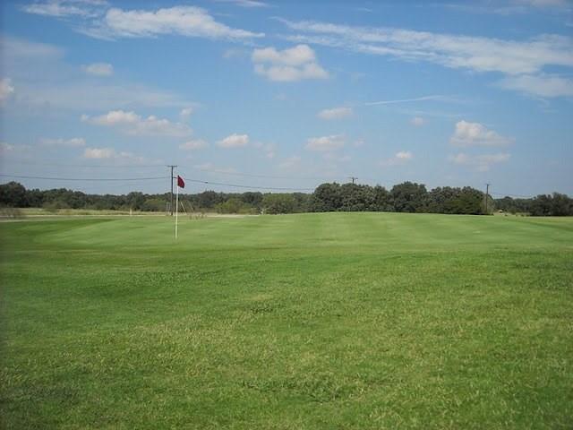10 Ridglea Court Nocona, TX 76255 - Photo 26 of 39 a view of a golf course with a lake