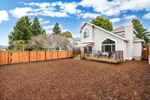 a view of a house with a backyard