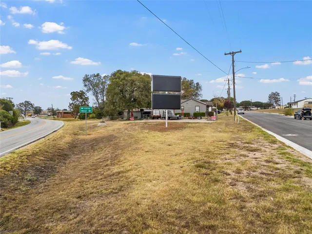 a view of a swimming pool with a patio and fire pit