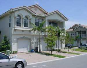 3104 Laurel Ridge Circle Riviera Beach, FL 33404 - Photo 2 of 7 a front view of a house with a garden