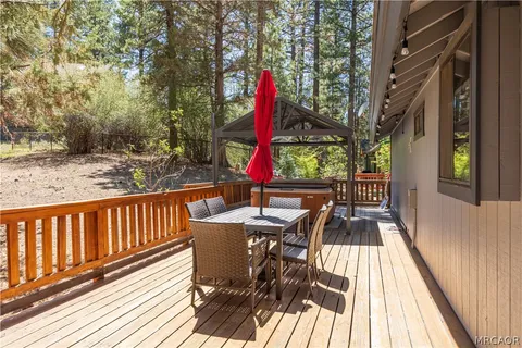 a view of balcony with wooden floor and outdoor seating