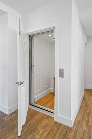 a living room with furniture a rug and a large window