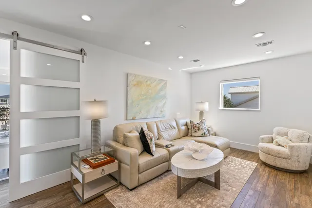 a living room with furniture and painting on the wall