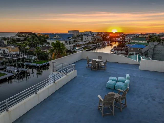 a view of a kitchen with wooden floor and electronic appliances