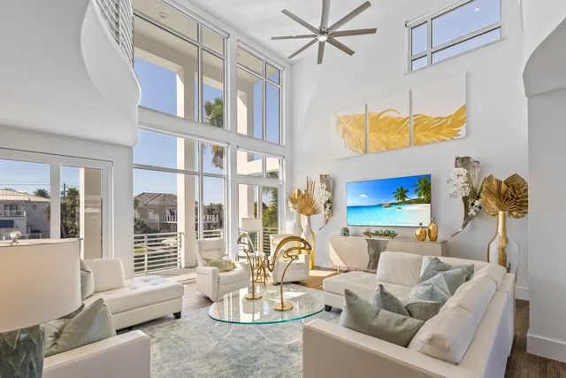 a view of a white house with a yard and sitting area